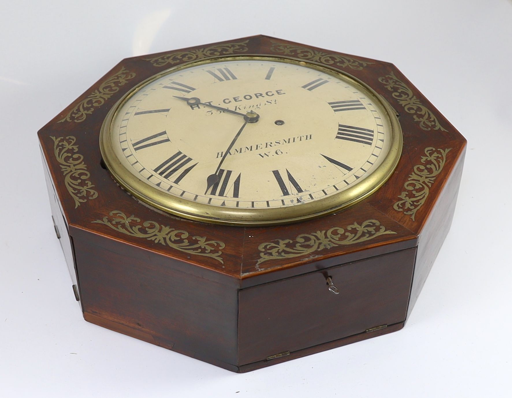 H.T. George, 358 King St, Hammersmith. A William IV octagonal rosewood dial clock 43cm.